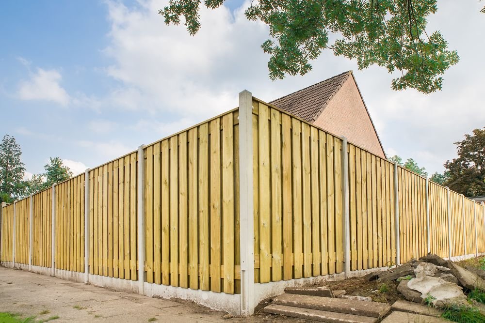 A rustic wooden fence featuring closely spaced vertical slats, emphasizing its natural texture and durability.